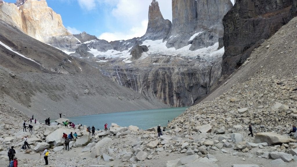 Hikers at the base of lake under the Torres del Paine