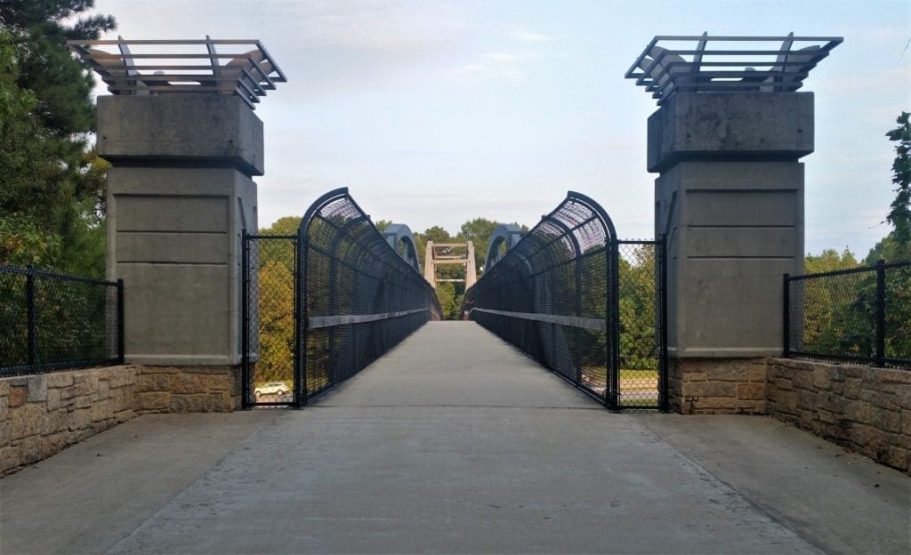 Pedestrian bridge over I-440 connects the Museum Park with House Creek Greenway and pathways to Meredith College and NC State.