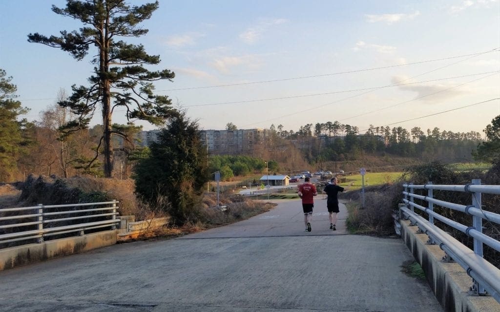 Joggers on the old I-40 bridge that is part of the MUT into Umstead from Old Reedy Creek trailhead.