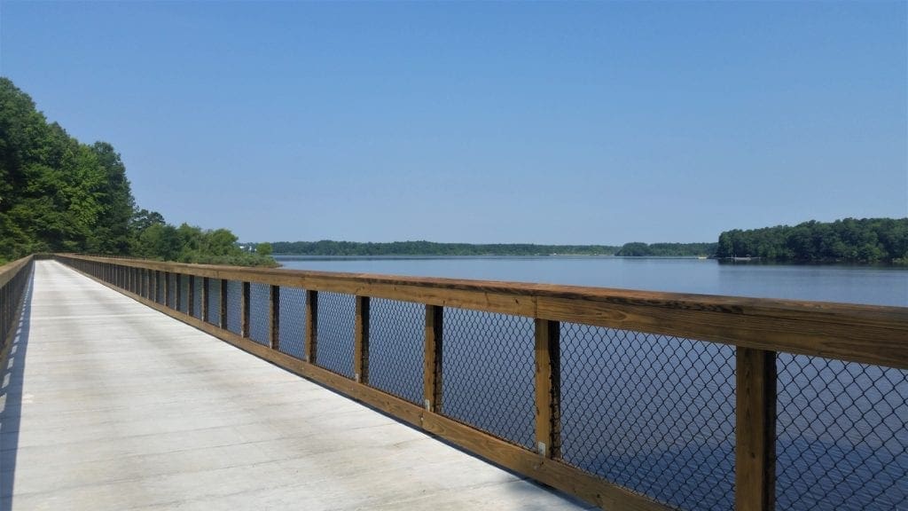 The Crabtree Creek Greenway begins on a bridge across the lake