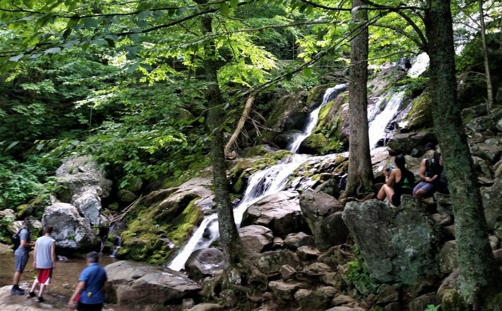 Hikers at Upper Dark Hollow Falls.