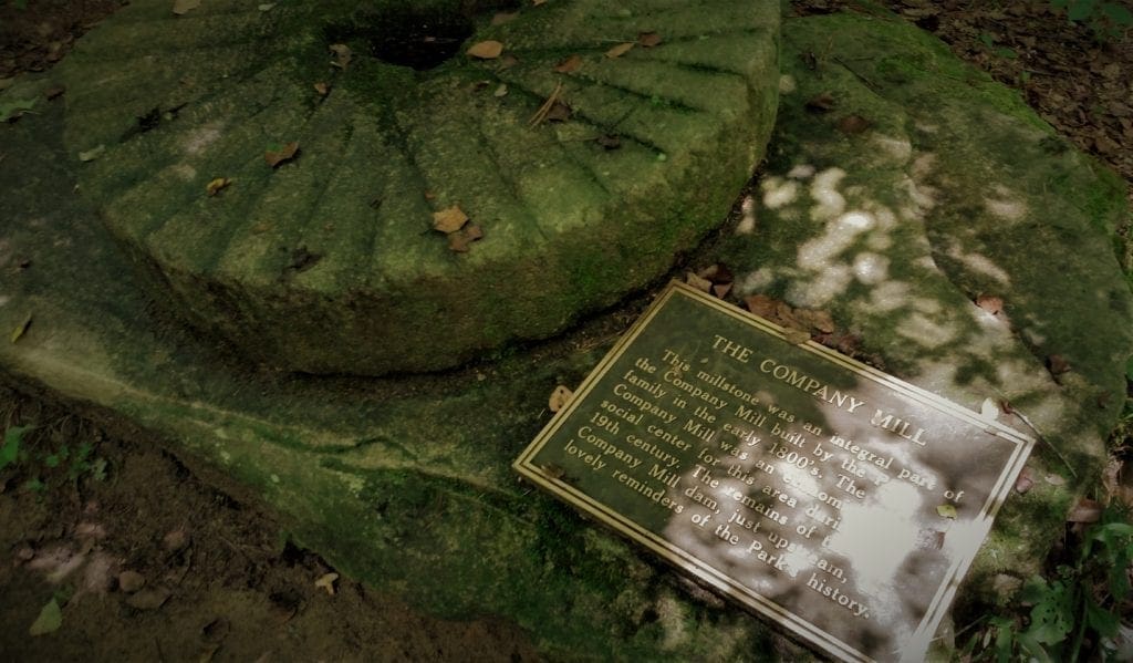 Preserved Company Mill millstone and plaque near the site.