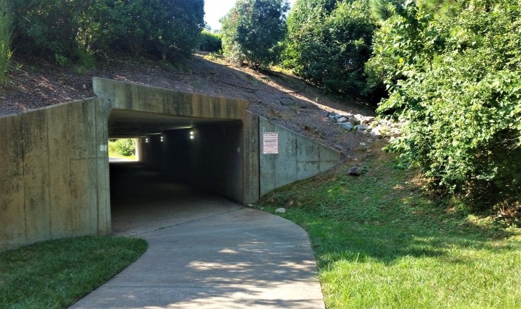 You'll pass through a tunnel that goes under Edwards Mill Road.