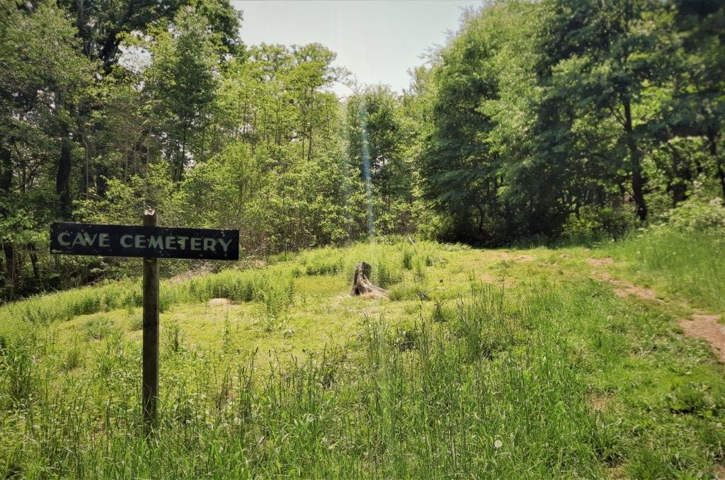 Wooden "Cave Cemetery" sign along the Fire Road.