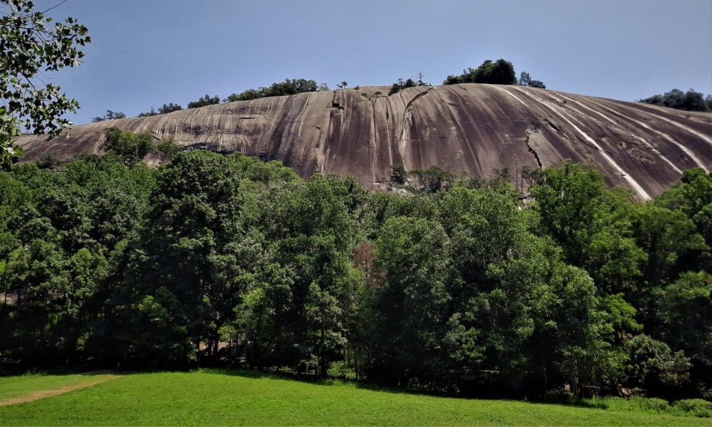 Stone Mountain's massive dome looms over the Hutchinson Homestead.