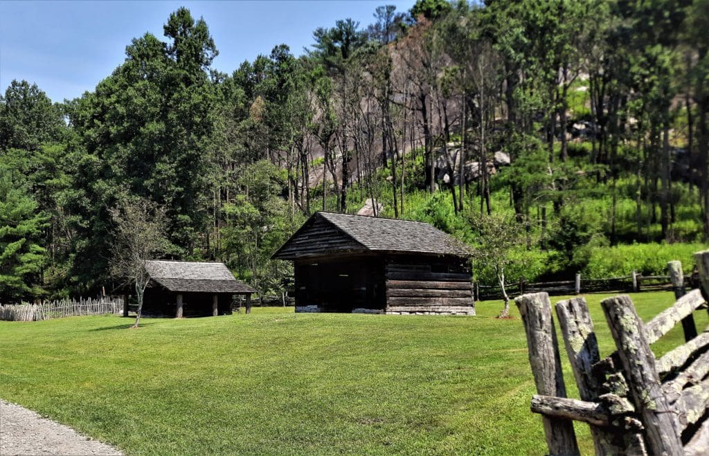 The log cabin and other structures on the Hutchinson Homestead.