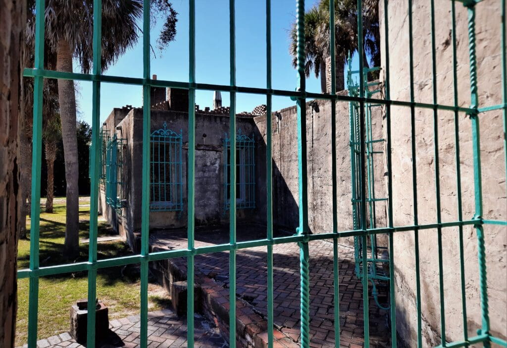 The windows are covered with wrought iron grills.
