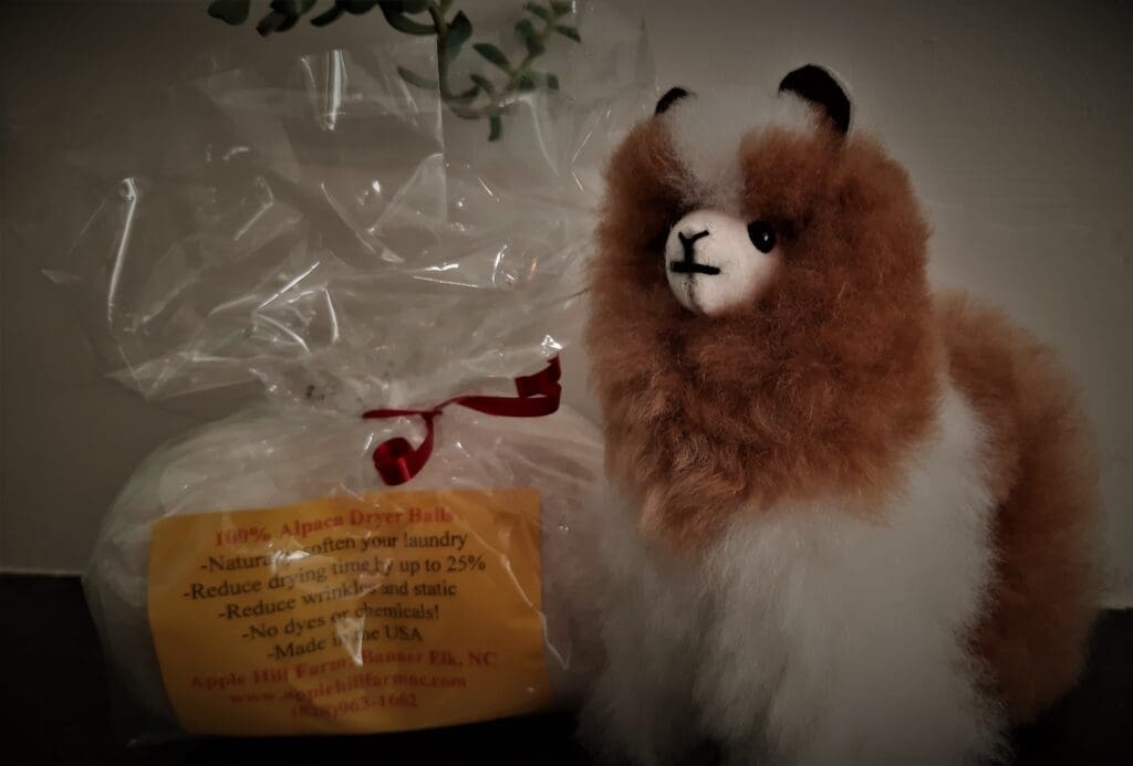 Alpaca stuffed animal and dryer balls are on sale t the store.