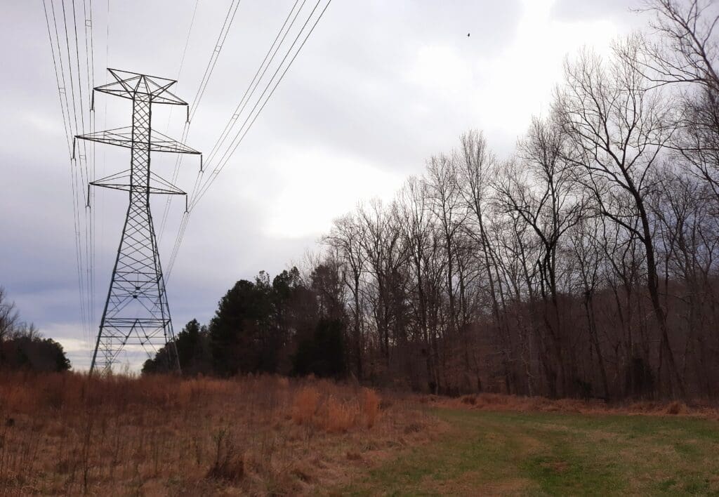 Follow the power line cut until it goes away from the river.