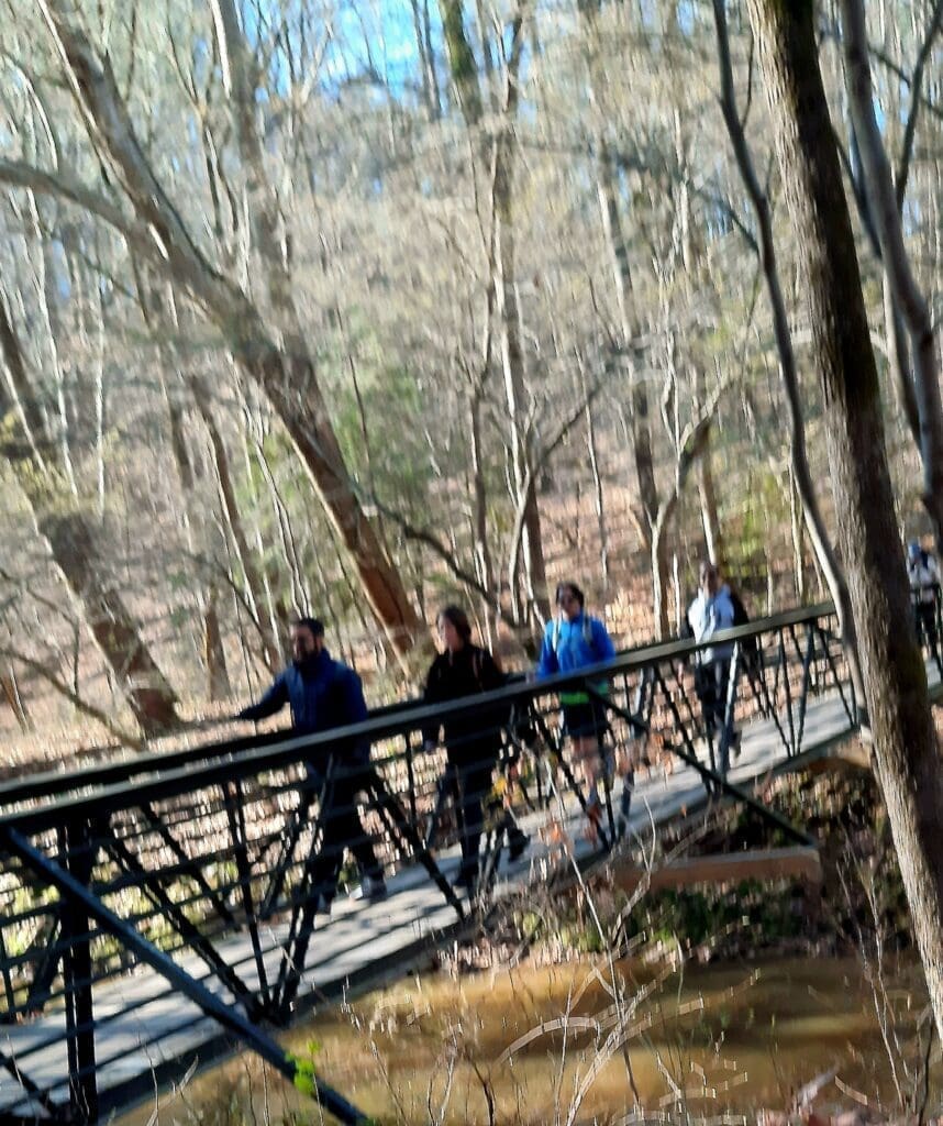 Hikers on the 1 Mile bridge on the Company Mill Trail.